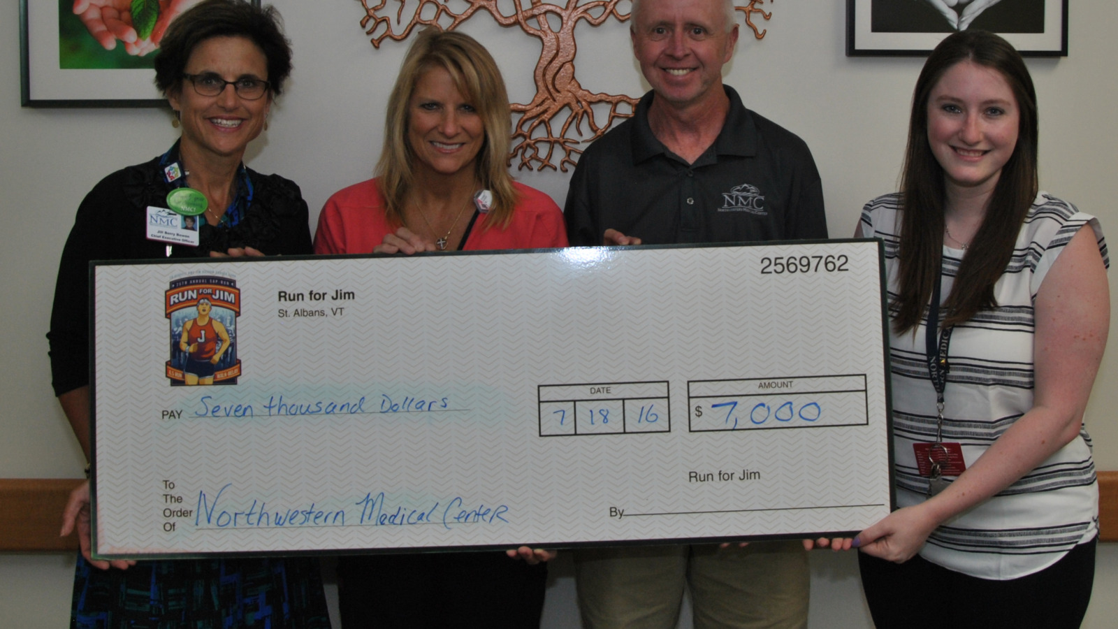 NMC Staff presenting a ceremonial check to representatives of the Jim Bashaw Fund