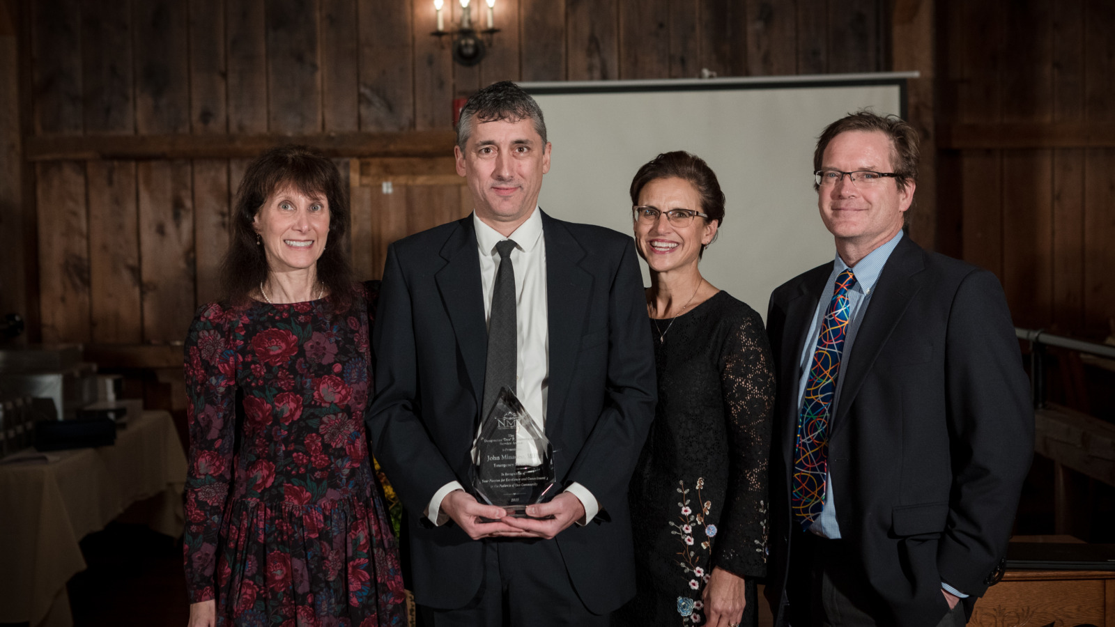 Dr. John Minadeo accepted the “Deo” P. Esguerra, MD Service Award recently. He’s pictured here with the award, and (from left to right) Dr. Toby Sadkin, CEO Jill Berry Bowen, RN and Chief Medical Officer, Dr. Lowrey Sullivan.