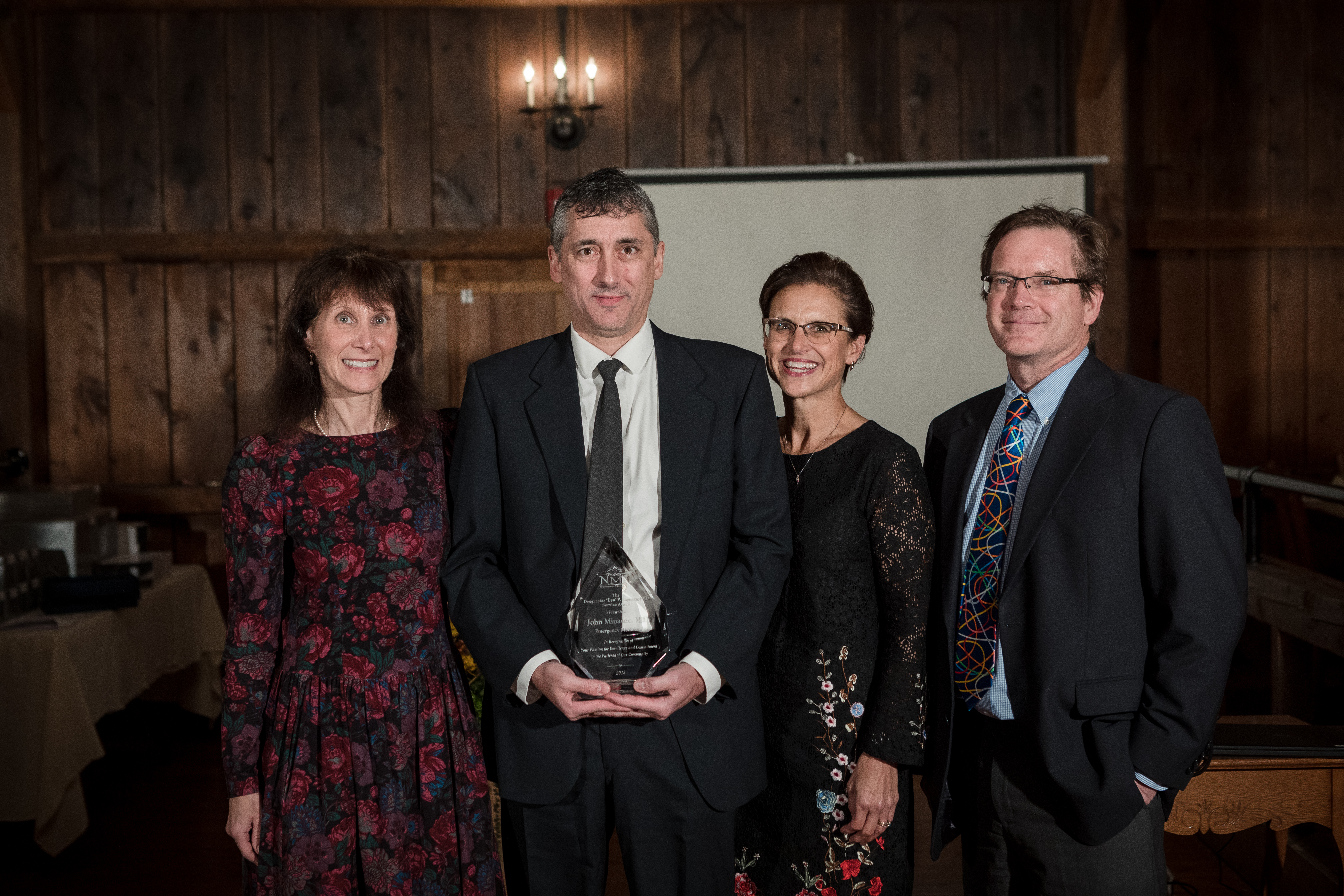 Dr. John Minadeo accepted the “Deo” P. Esguerra, MD Service Award recently. He’s pictured here with the award, and (from left to right) Dr. Toby Sadkin, CEO Jill Berry Bowen, RN and Chief Medical Officer, Dr. Lowrey Sullivan.