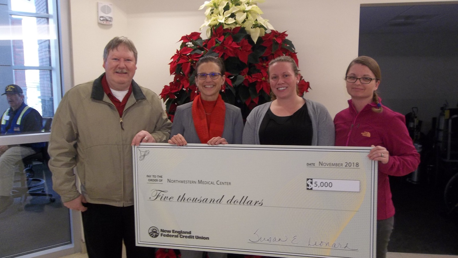 NMC Staff accepting a ceremonial check from New England Federal Credit Union