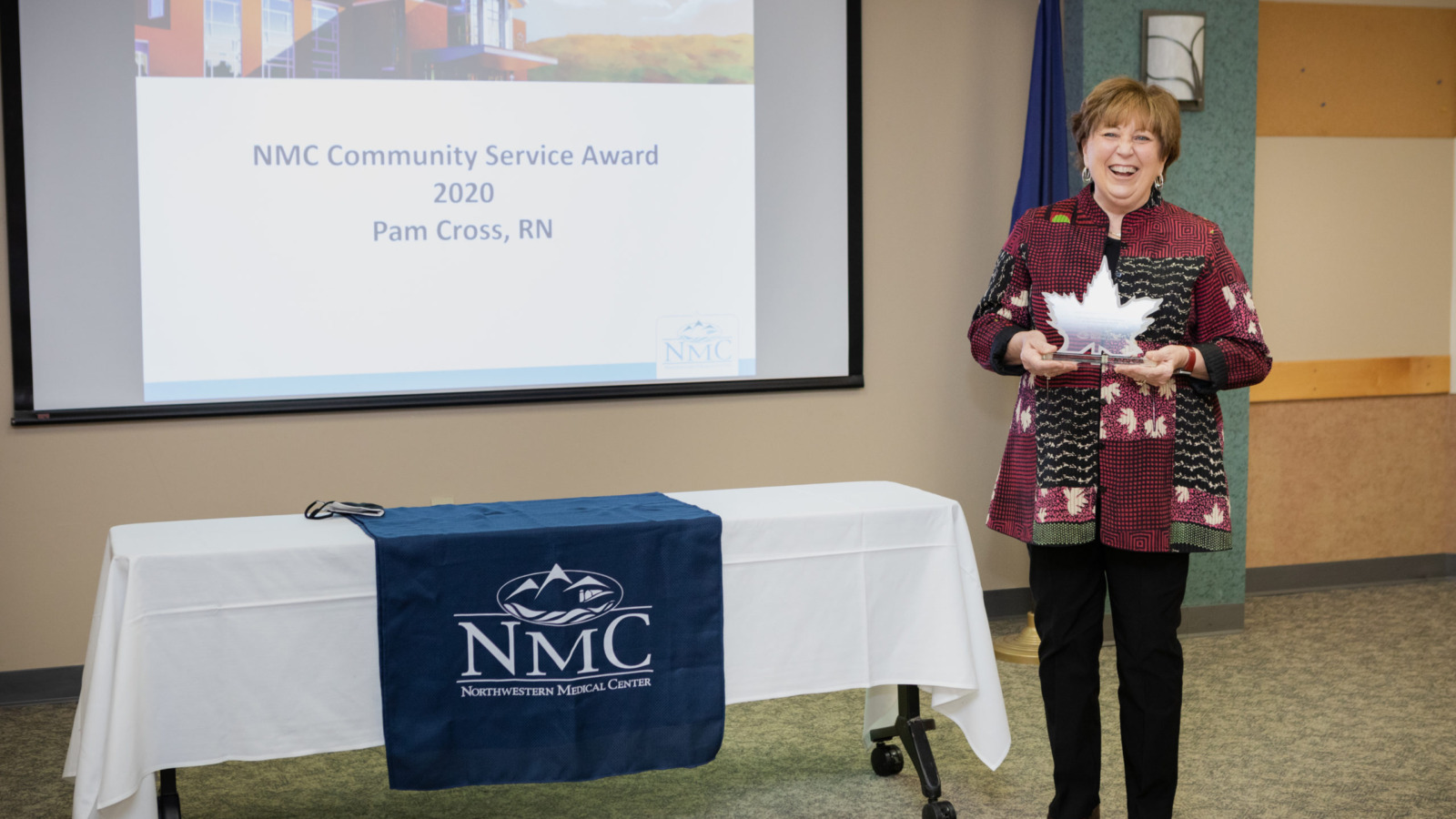 Registered nurse Pam Cross holding the Community Service Award