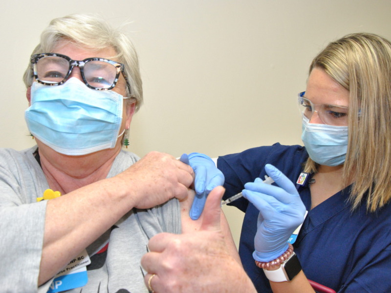 Nurse administering covid-19 vaccination