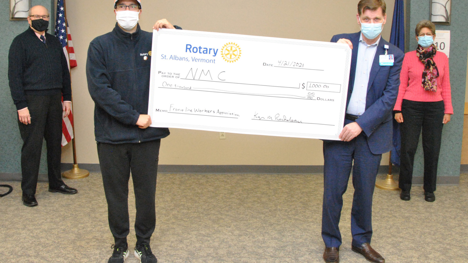 Rotary presenting former NMC CEO Dean French with a $1000 ceremonial check