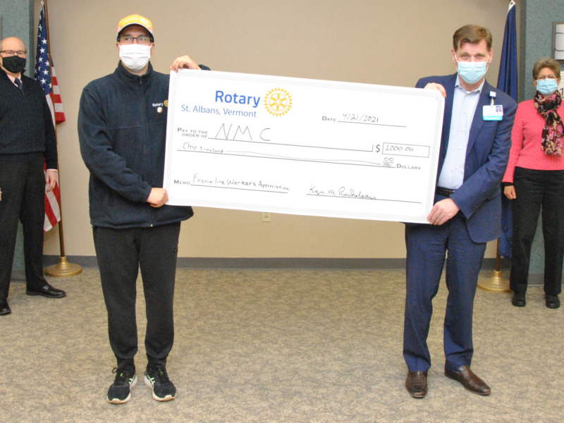 Rotary presenting former NMC CEO Dean French with a $1000 ceremonial check