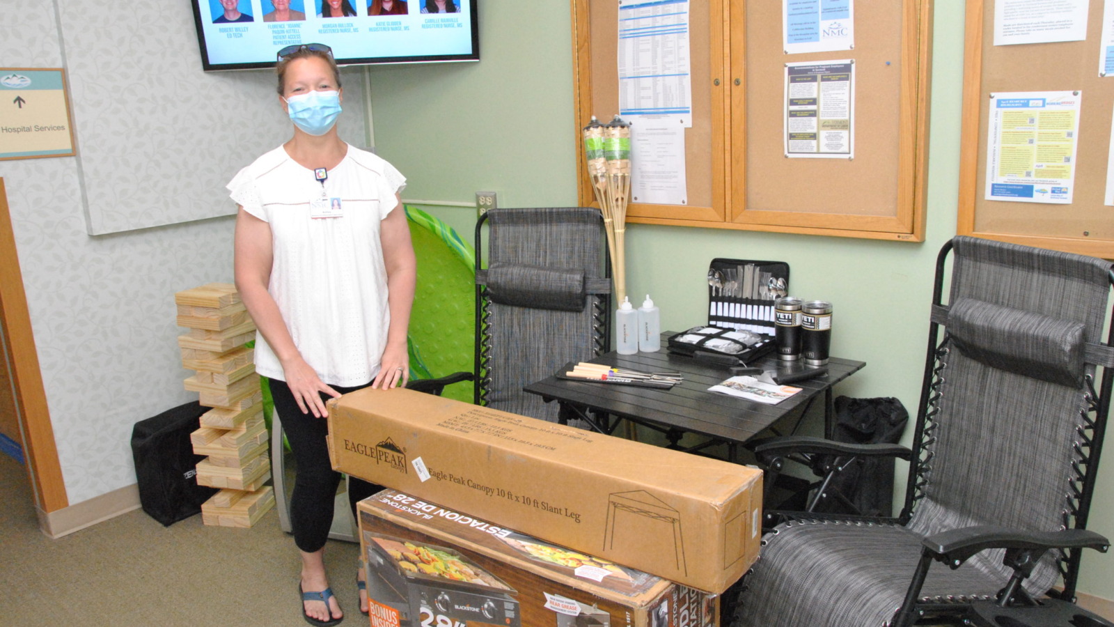 Staff member showing off prizes for annual Hospital week celebrations