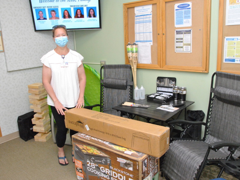 Staff member showing off prizes for annual Hospital week celebrations