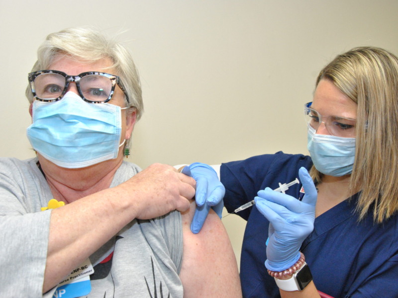 Nurse administering a covid vaccine