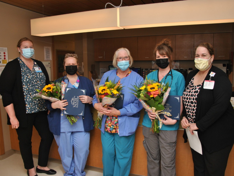 Group of NMC nurses being presented with flowers during nurses' week