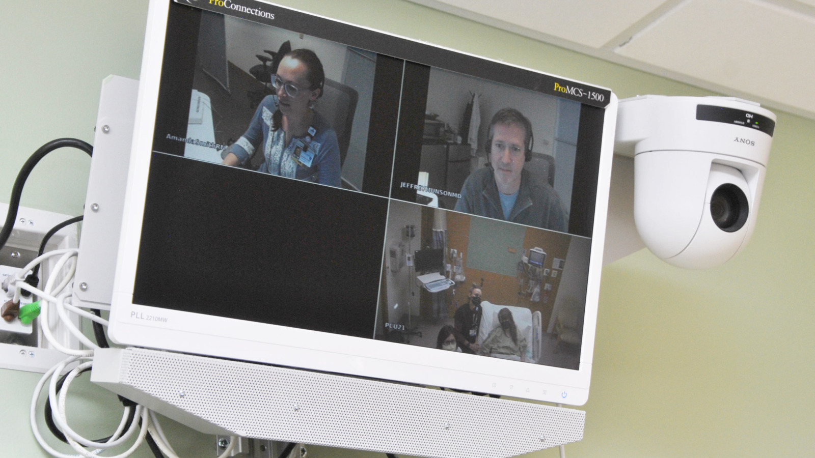 computer monitor with image of providers caring for patients remotely