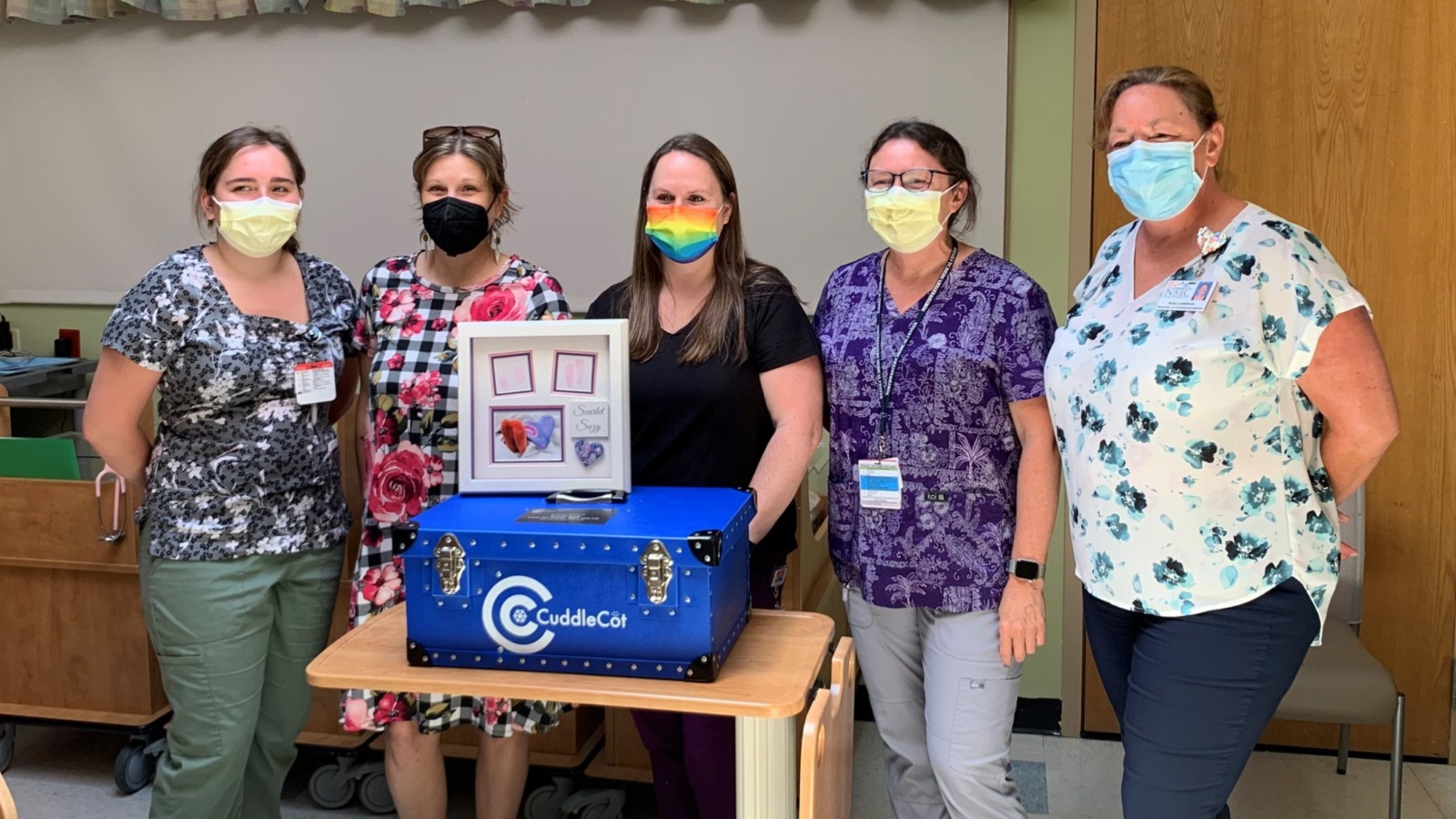 Northwestern Medical Center staff accept a donation of a cuddle cot