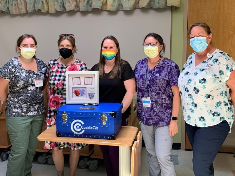 Northwestern Medical Center staff accept a donation of a cuddle cot