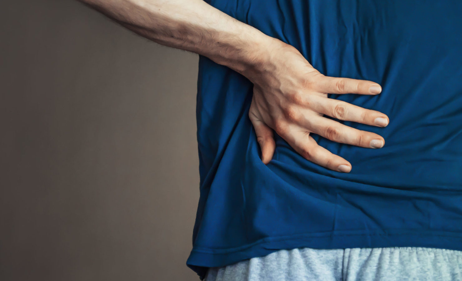 A man holding his back in pain