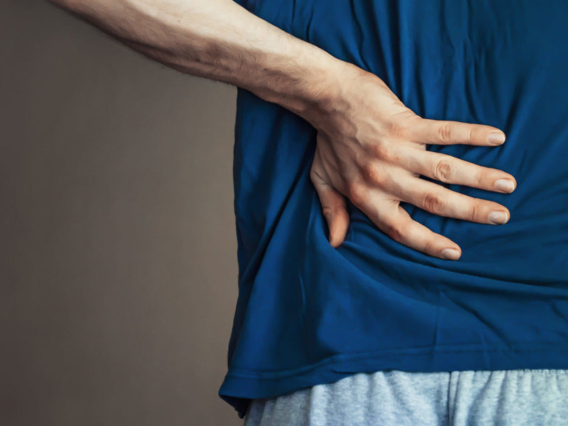 A man holding his back in pain