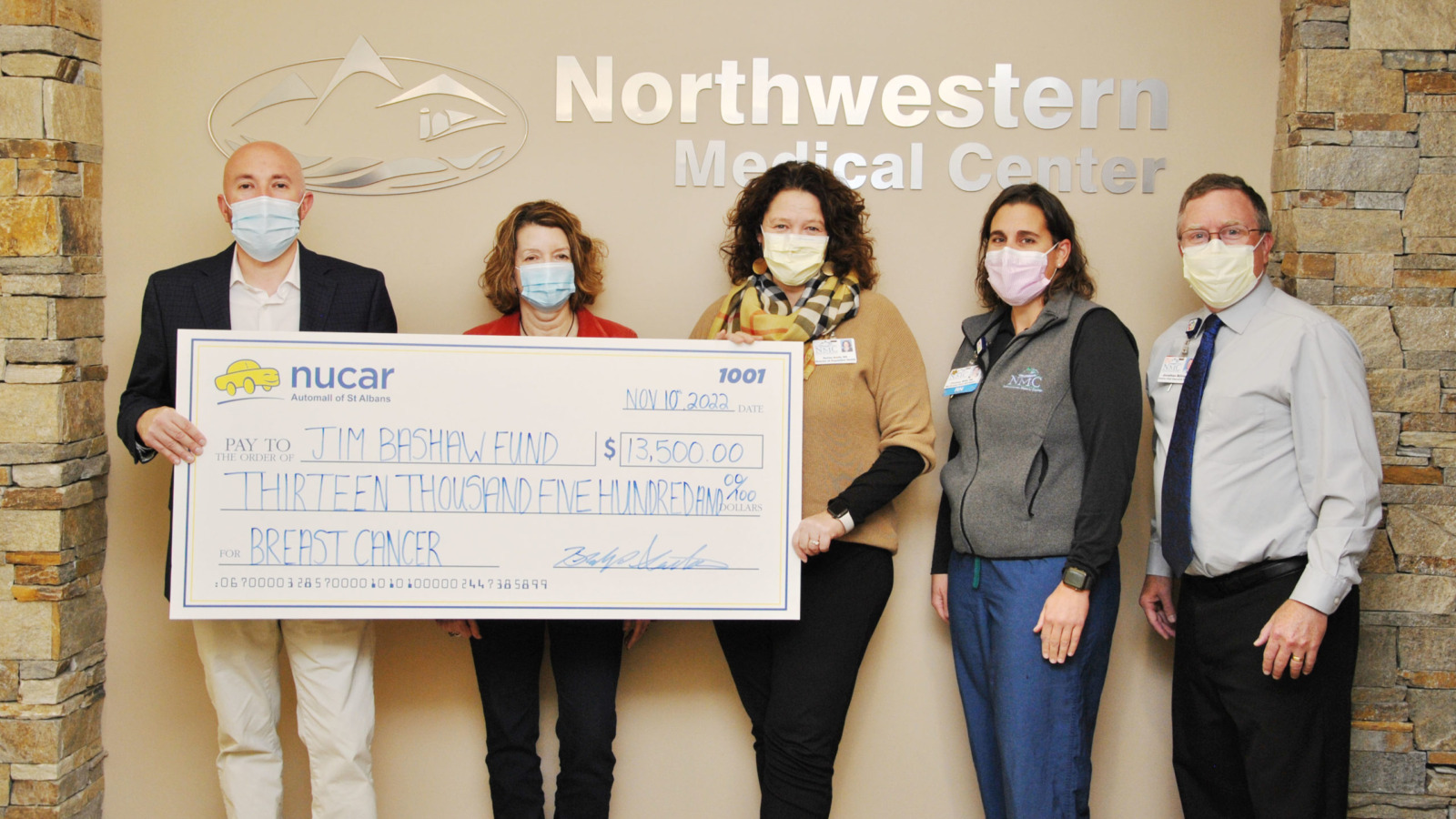 Northwestern Medical Center staff members presenting ceremonial check to representatives of the Jim Bashaw Fund
