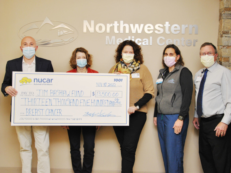 Northwestern Medical Center staff members presenting ceremonial check to representatives of the Jim Bashaw Fund