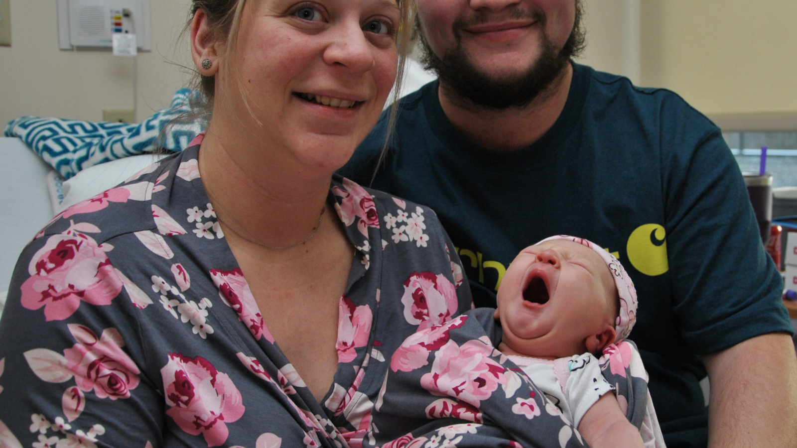 Parents holding newborn daughter, Vermont's first baby of 2023