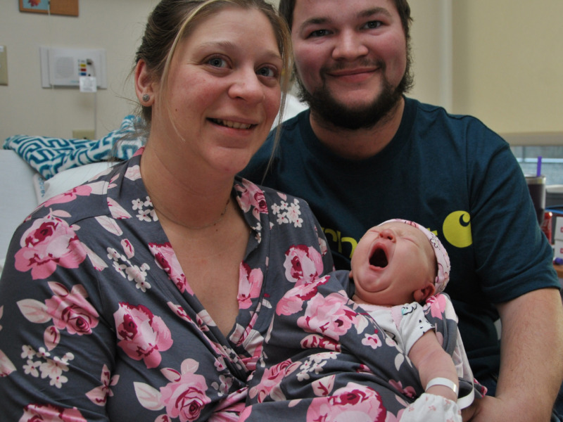 Parents holding newborn daughter, Vermont's first baby of 2023