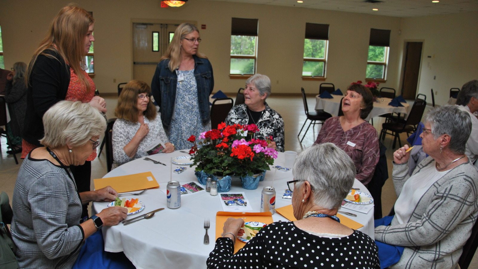 Group of Northwestern Medical Center's volunteers enjoying a snack and conversation