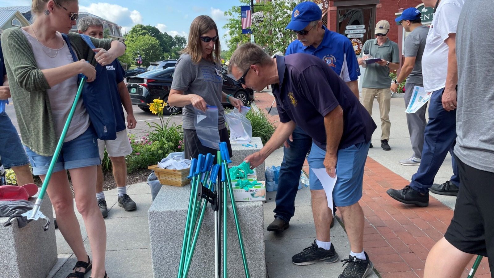 Group of community members collecting equipment to use during a cigarette butt litter clean up event