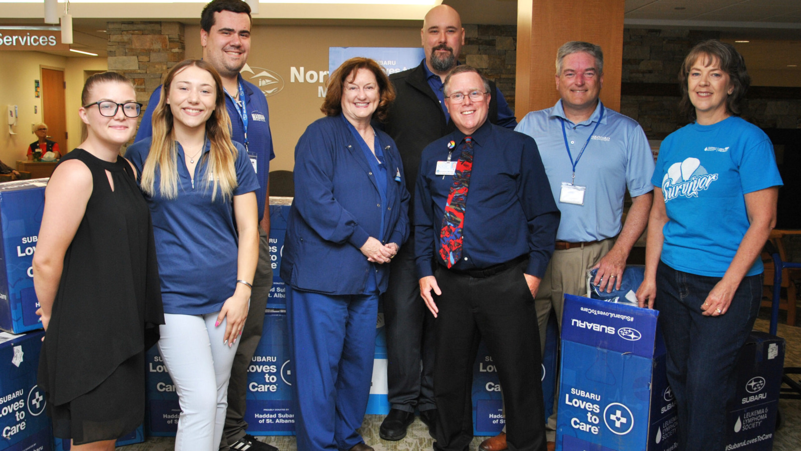 NMC staff accepting a donation from local subaru dealership