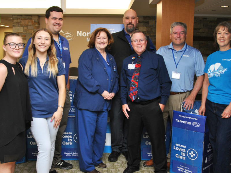 NMC staff accepting a donation from local subaru dealership