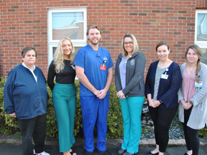 Group picture of nurses in front of an exterior wall