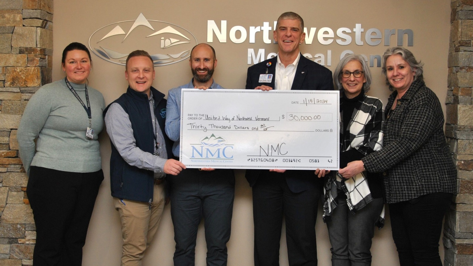CEO Peter Wright and staff awarding ceremonial check for $30,000 to representatives of the United Way of Vermont