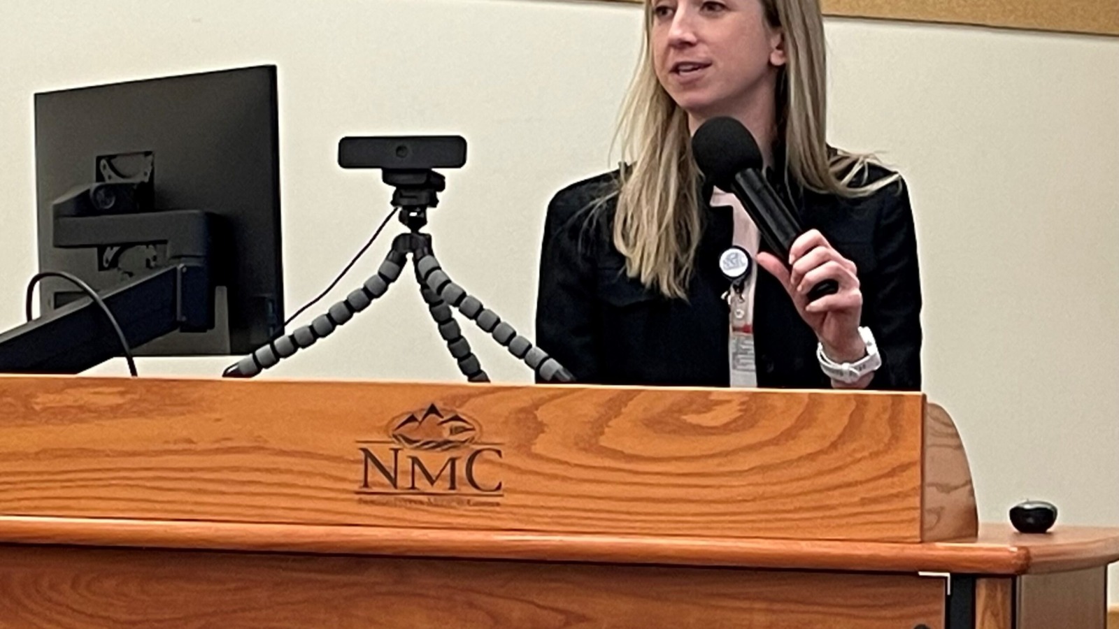 Doctor Kristen Kindred speaking at a podium