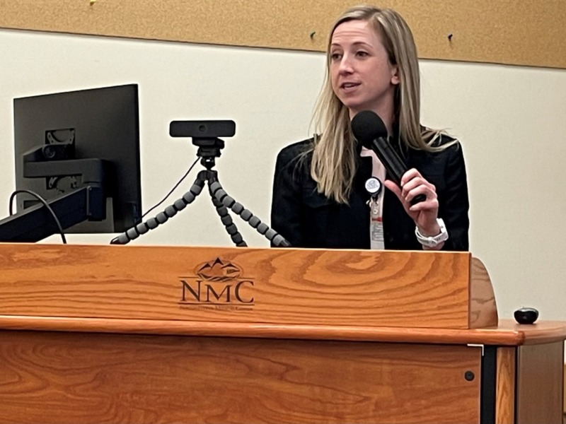 Doctor Kristen Kindred speaking at a podium