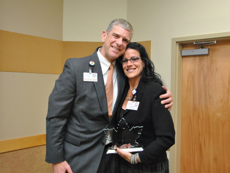 Peter Wright, CEO Northwestern Medical Center presenting NMC's Community Service Award to Melinda White