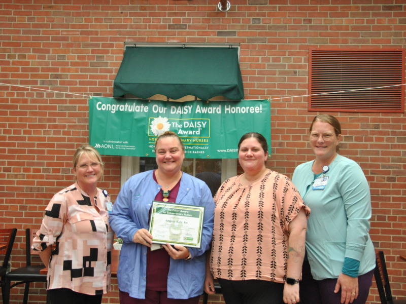 Daisy Award winner Angie Aulis posing with colleagues