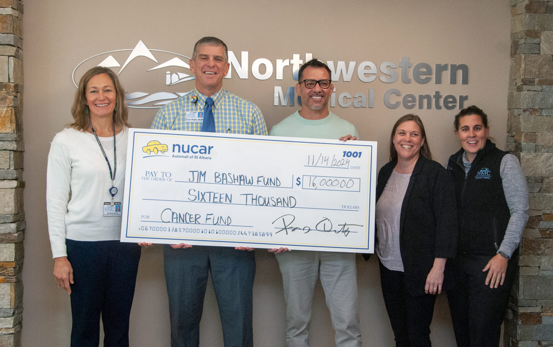 Peter Wright, CEO and other hospital staff presenting a ceremonial check donation to the Jim Bashaw Fund