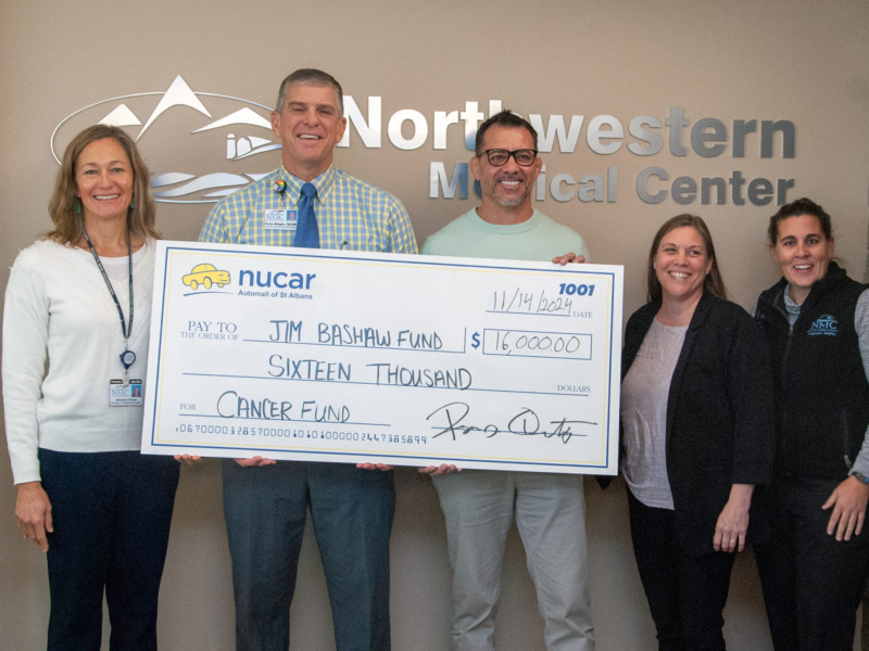 Peter Wright, CEO and other hospital staff presenting a ceremonial check donation to the Jim Bashaw Fund