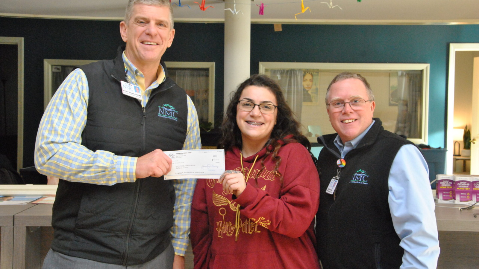 Peter Wright, CEO and Jonathan Billings COO at Northwestern Medical Center present a donation check to a representative of Spectrum Youth and Family Services.