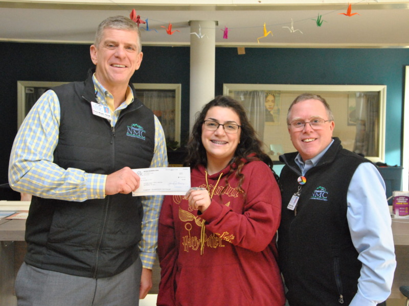Peter Wright, CEO and Jonathan Billings COO at Northwestern Medical Center present a donation check to a representative of Spectrum Youth and Family Services.