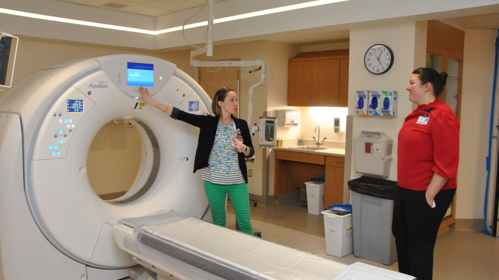 Northwestern Medical Centers lead CAT Scan Technologist Cynthia Bemis demonstrates a new CAT Scan machine to Northwestern's CFO, Stephanie Breault