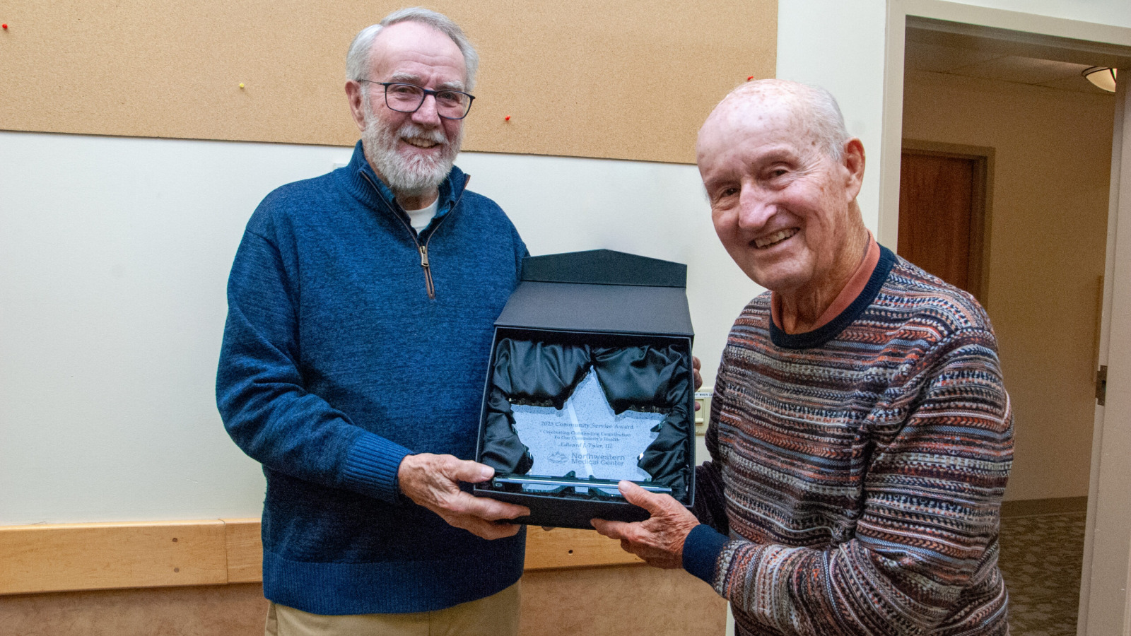 Edward J Tyler receives Northwestern Medical Centers 2025 Community Service award from a hospital Board Member