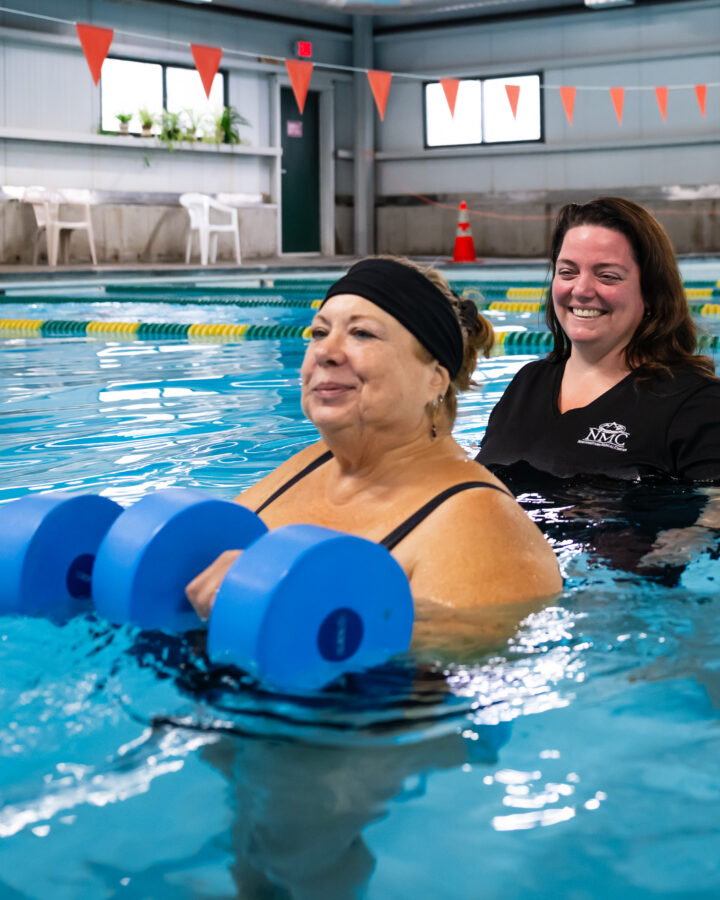 aquatic therapist guiding patient