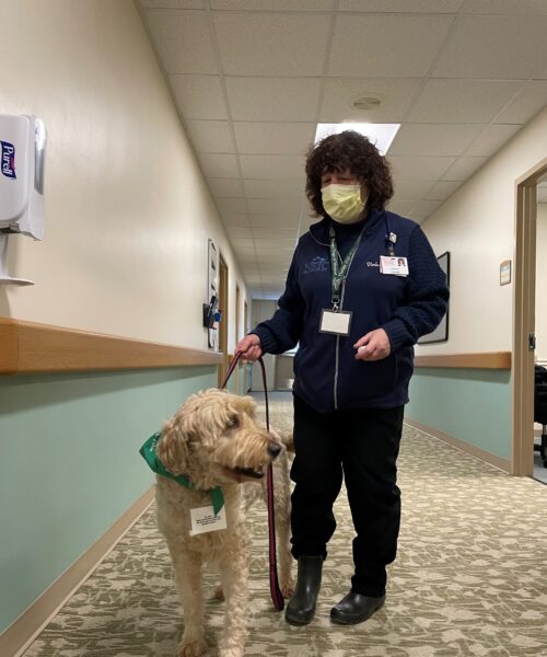 Pet Therapy volunteer Colleen and her dog Brynn standing in hallway at Northwestern Medical Center