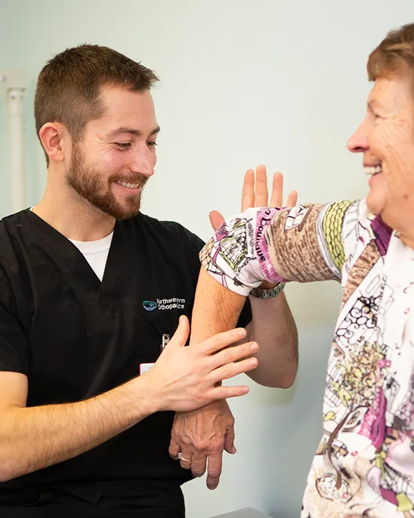 Provider examining elbow movement of patient