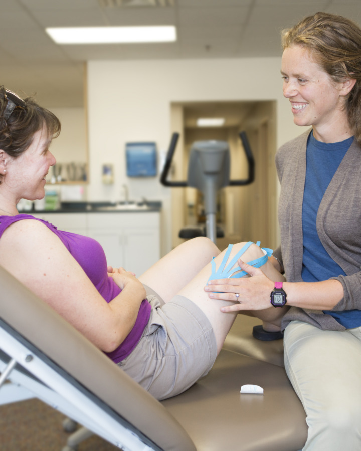 Physical Therapist applying Kinesiotape