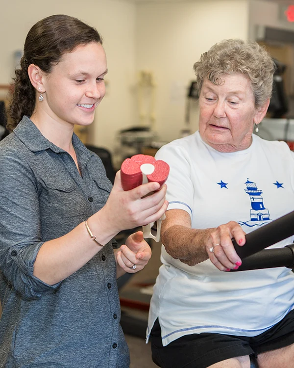Physical Therapy provider explaining a model of the leg to a patient