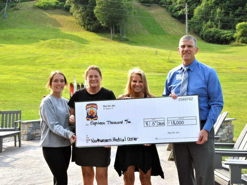 CEO Peter Wright and Run for Jim organizers standing for check presentation