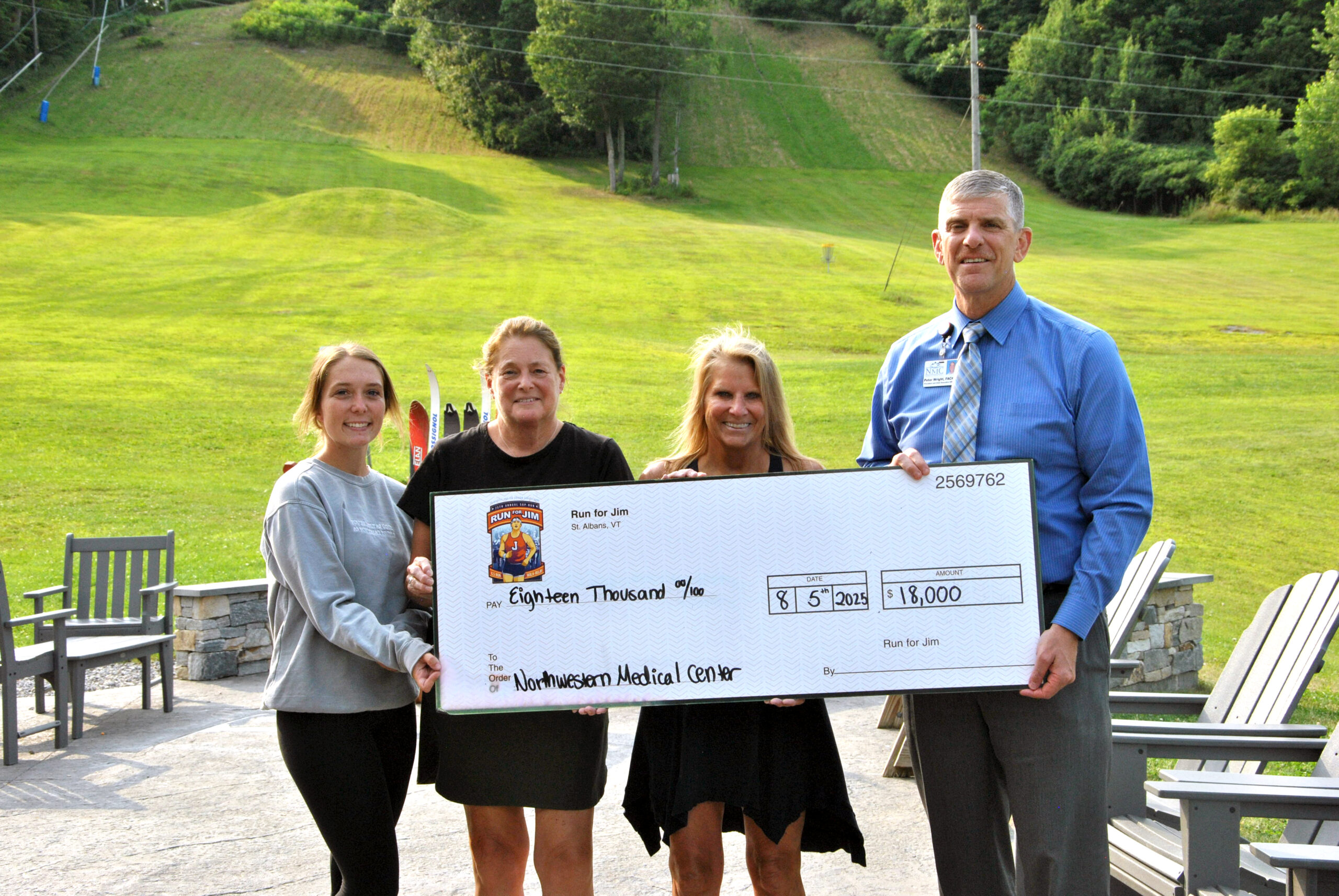 CEO Peter Wright and Run for Jim organizers standing for check presentation