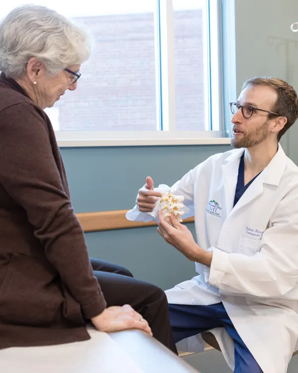 Dr Mauser speaking with spine care patient