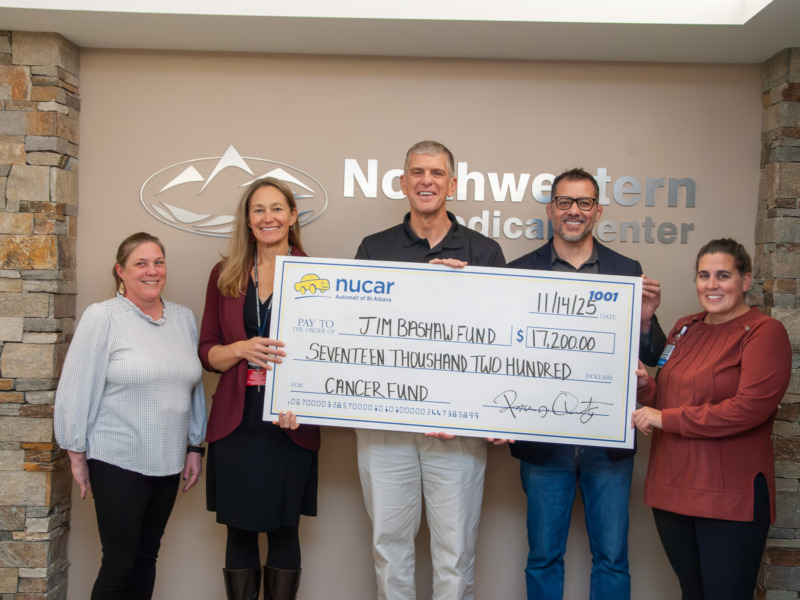 Check being presented to NMC by Nucar Automall of St. Albans for Jim Bashaw Fund