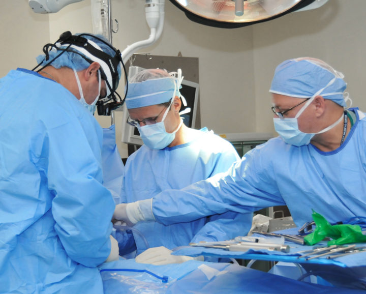 three surgeons during surgery