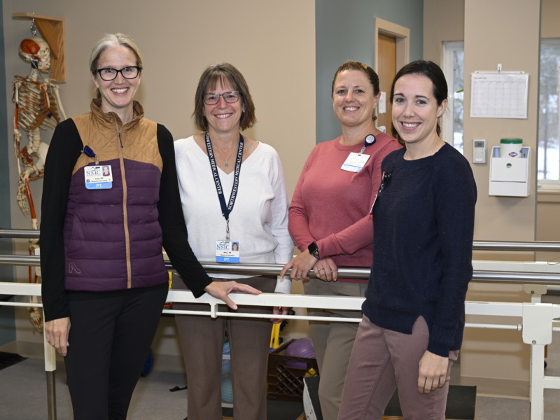 Physical Therapists gathered for group photo in gym