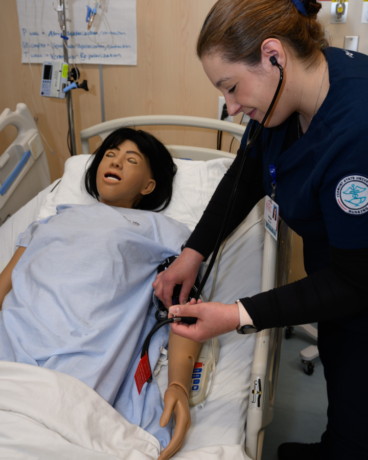 Licensed Practicing Nurse taking part in Simulation Lab and examining patients heart rate