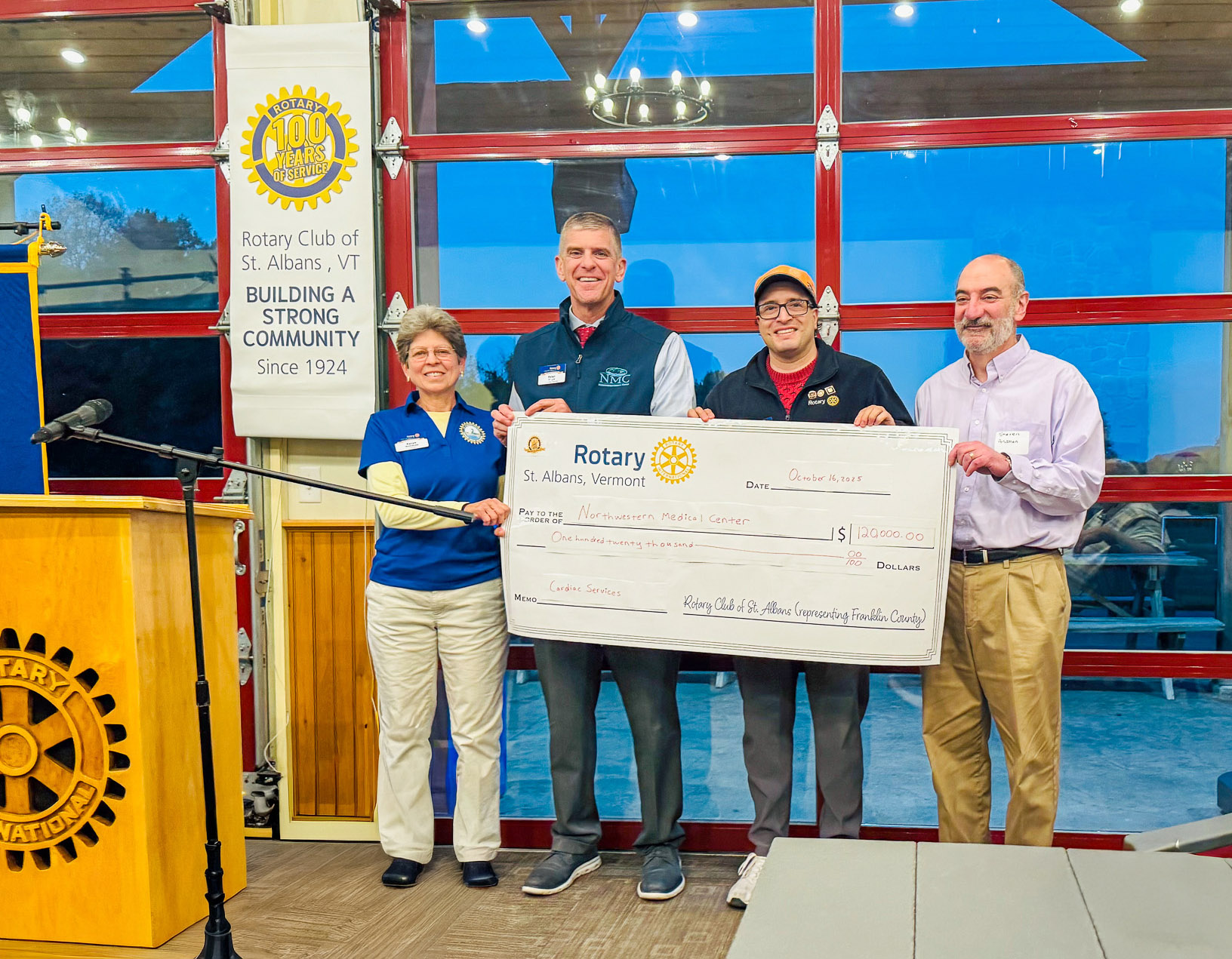 A check being presented to the St. Albans Rotary